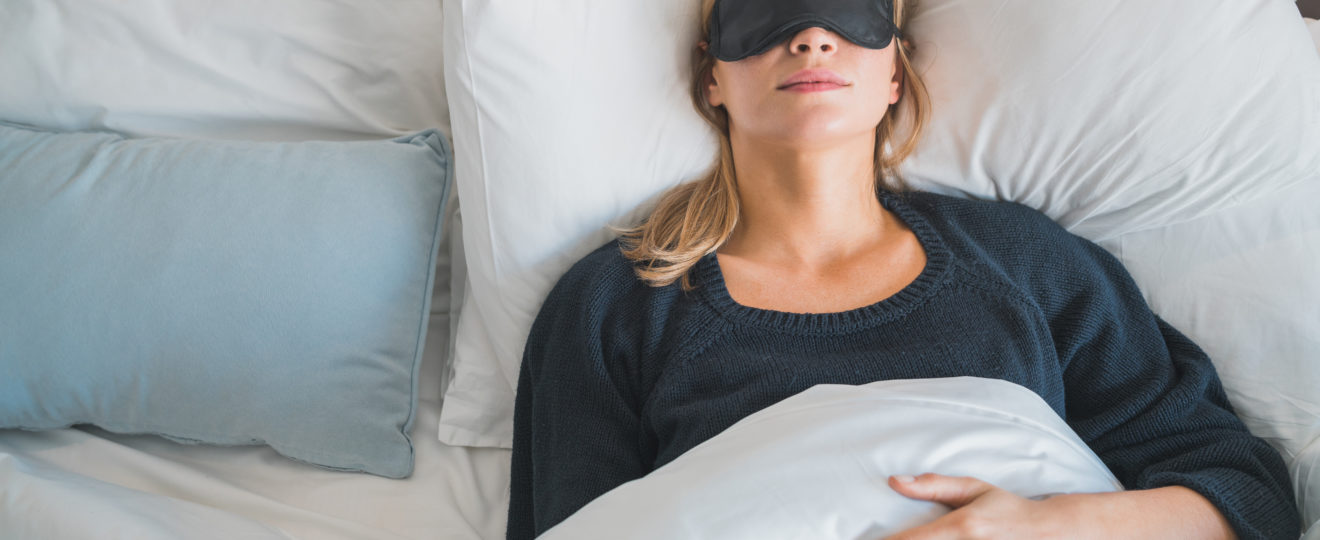 Woman sleeping with sleep mask.