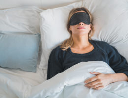 Woman sleeping with sleep mask.