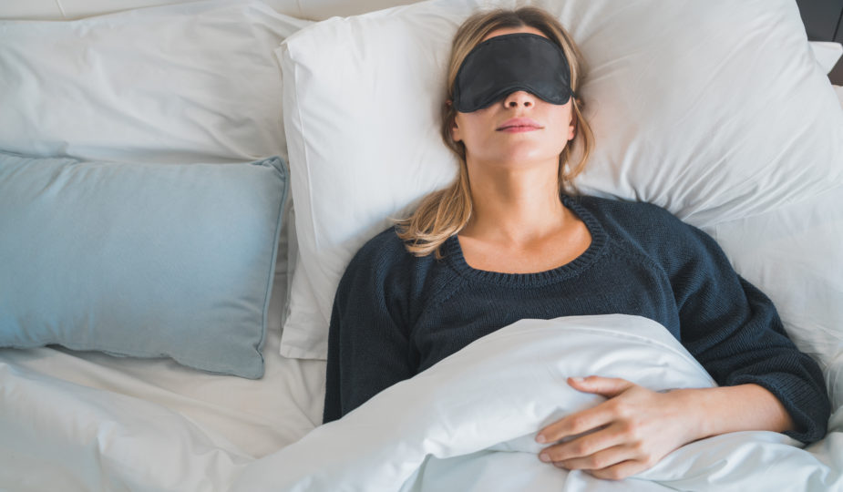 Woman sleeping with sleep mask.