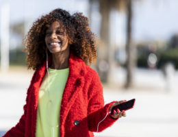 Young afro american woman laughing while dancing outdoors